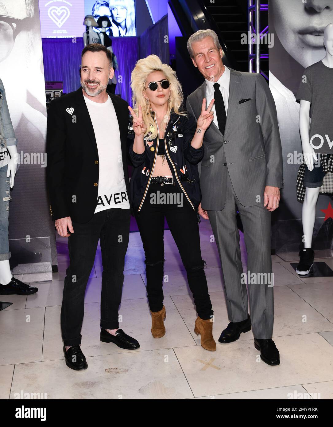 Recording artist Lady Gaga, left, David Furnish, chairman of the Elton John AIDS Foundation and Macy's CEO Terry J. Lundgren attend the launch of "Love Bravery" at Macy's Herald Square on Wednesday, May 4, 2016, in New York. Proceeds from "Love Bravery" items will benefit the Born This Way and Elton John AIDS Foundations. (Photo by Evan Agostini/Invision/AP) Banque D'Images
