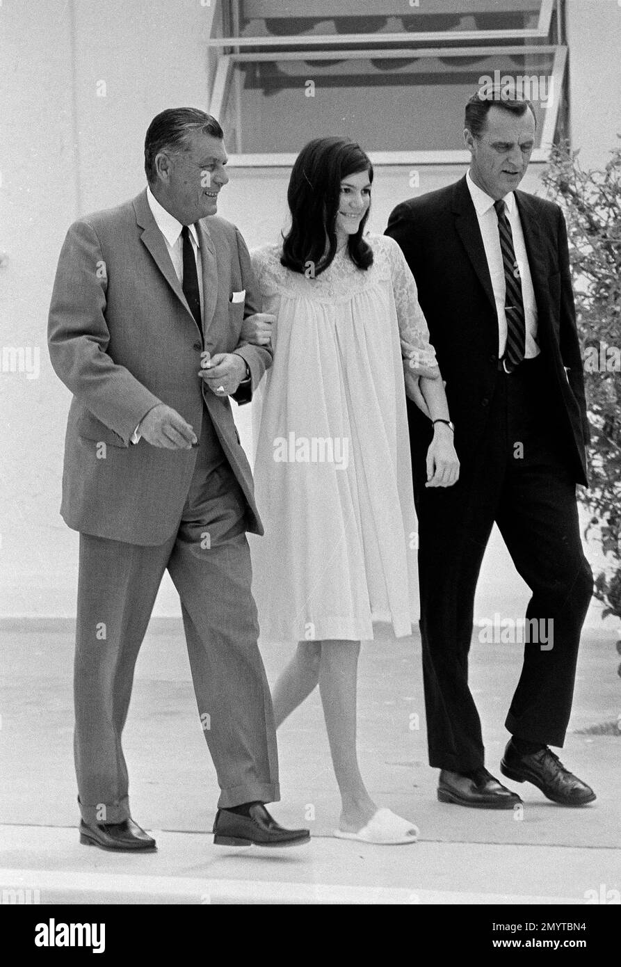 Barbara Mackle walks arm in arm with her father, Robert Mackle, left ...