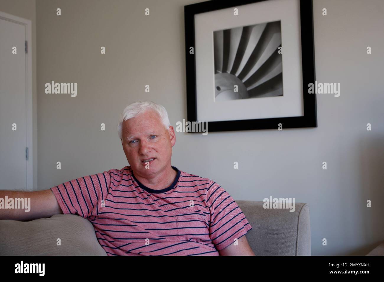 In this Feb. 9, 2016 photo, jetpack inventor Glenn Martin sits at his home in Christchurch, New Zealand. Martin Aircraft Co. says it’s close to commercial liftoff, but Glenn Martin fears his vision of a personal jetpack will remain grounded. (AP Photo/Nick Perry) Banque D'Images
