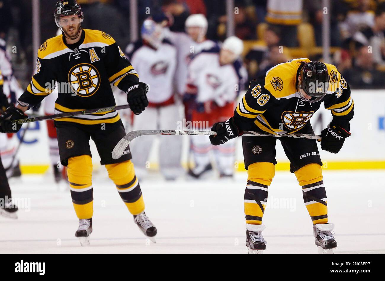 Boston Bruins' David Pastrnak (88) and David Krejci (46) skate off the ice after the Columbus Blue Jackets defeated the Bruins 6-4 during an NHL hockey game in Boston, Monday, Feb. 22, 2016. (AP Photo/Michael Dwyer) Banque D'Images