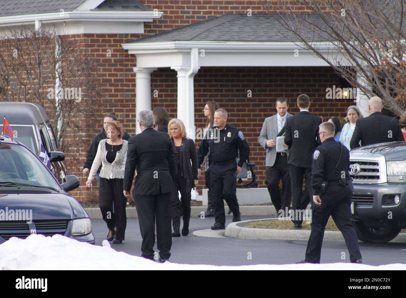 Mourners leave a funeral home after attending the funeral for 13year