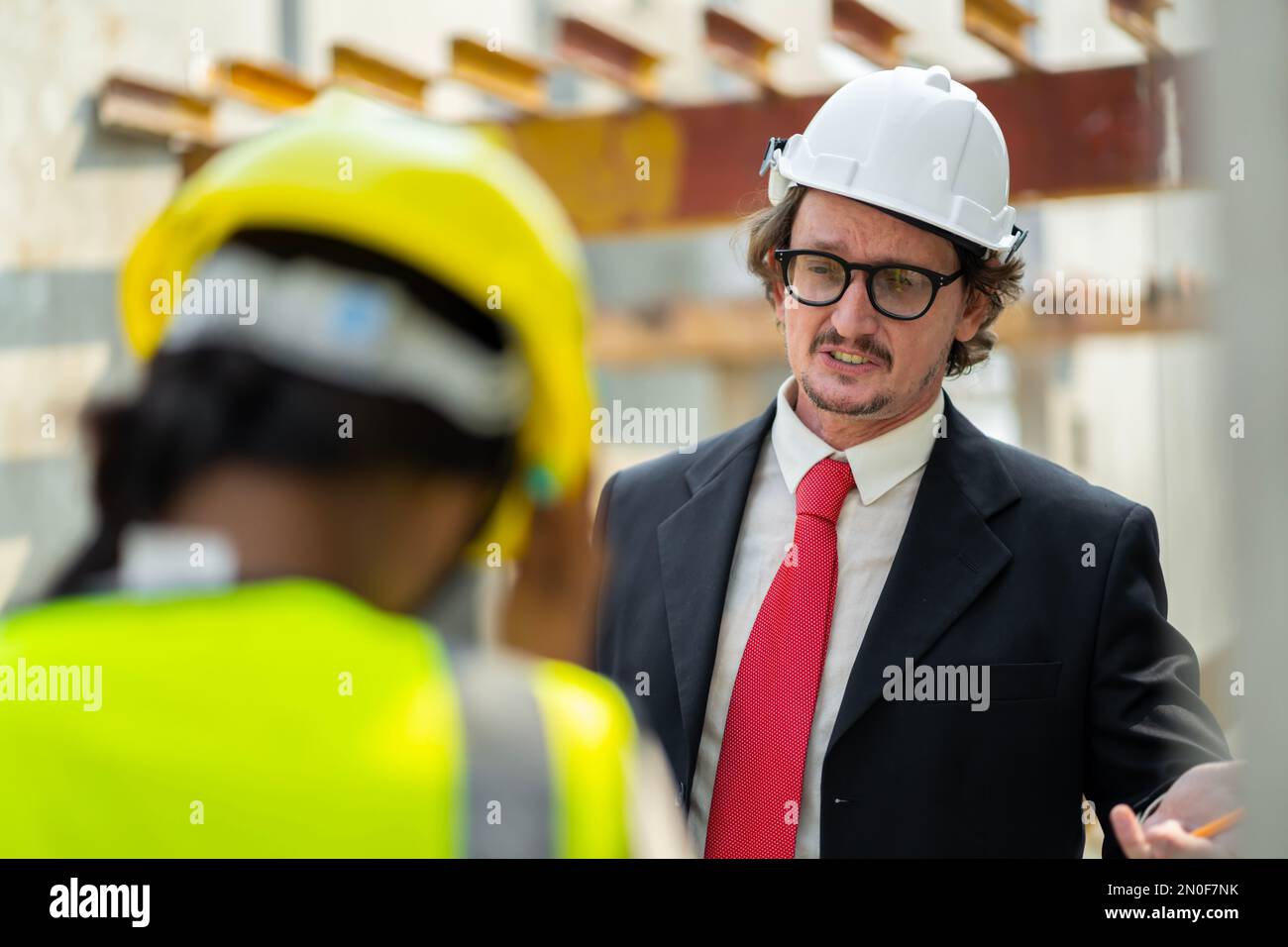 Les ingénieurs masculins inspectent et contrôlent le travail des employés et la qualité des produits manufacturés pour répondre aux normes. Dans industr Banque D'Images