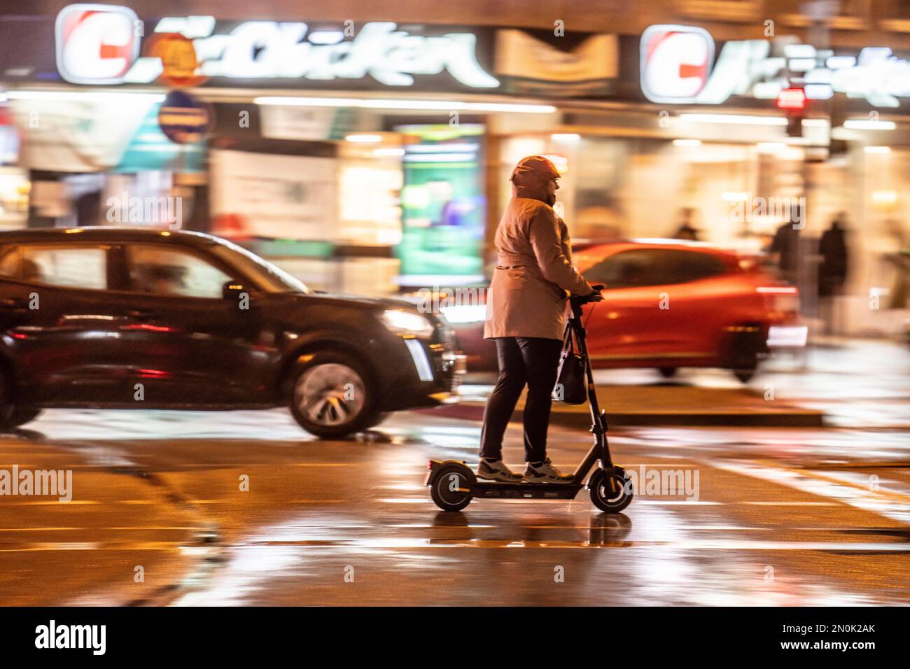 Rue à la gare principale, e-scooter conducteur temps pluvieux, centre ville, dans la soirée, Essen, NRW, Allemagne, Banque D'Images