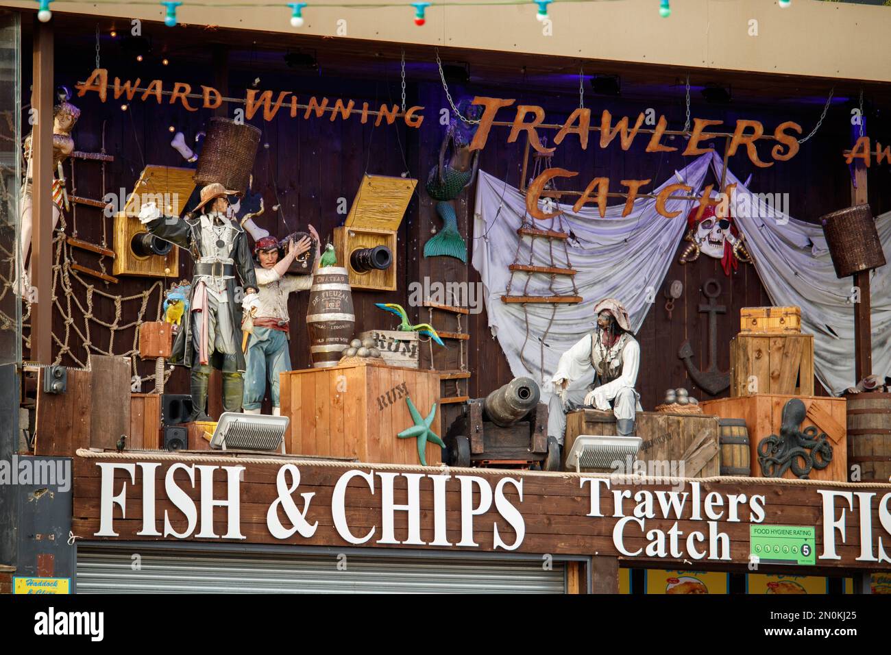 Les chalutiers attrapent une boutique de poissons et de puces sur la route principale près du front de mer de Skegness, une station de vacances populaire. Banque D'Images