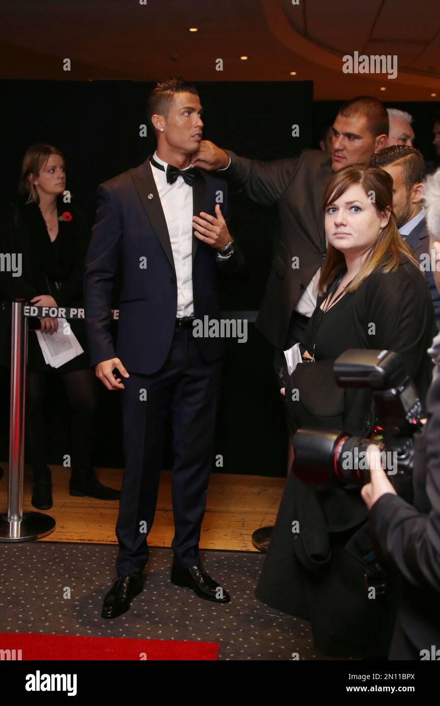 Cristiano Ronaldo has his tie adjusted by security before he poses for photographers upon arrival at the world premiere of the film 'Ronaldo, in London, Monday, Nov. 9, 2015. (Photo by Joel Ryan/Invision/AP) Banque D'Images