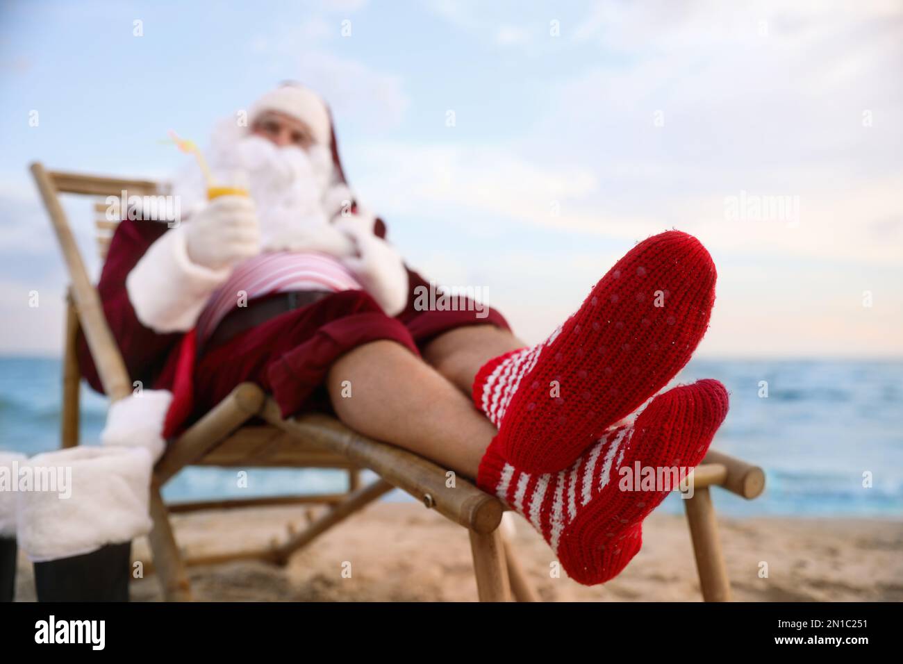 Le Père Noël se détend sur la plage. Vacances de Noël Banque D'Images