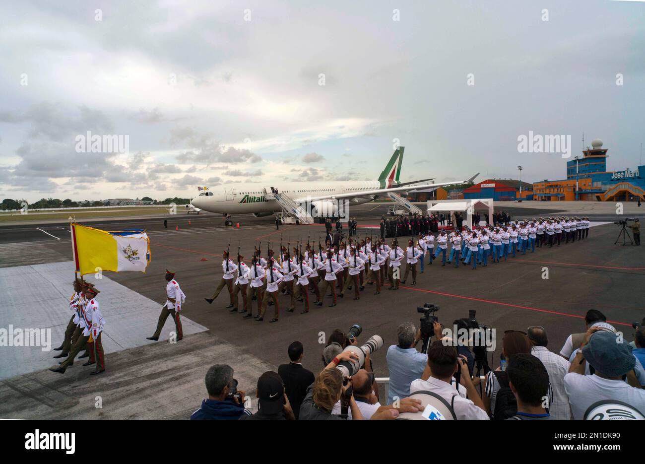 Soldiers march while members of the press focus on the plane carrying Pope Francis moments after the pope's plane landed at the airport in Havana, Cuba, Saturday, Sept. 19, 2015. Pope Francis begins a 10-day trip to Cuba and the United States on Saturday, embarking on his first trip to the onetime Cold War foes after helping to nudge forward their historic rapprochement. (AP Photo/Ramon Espinosa) Banque D'Images