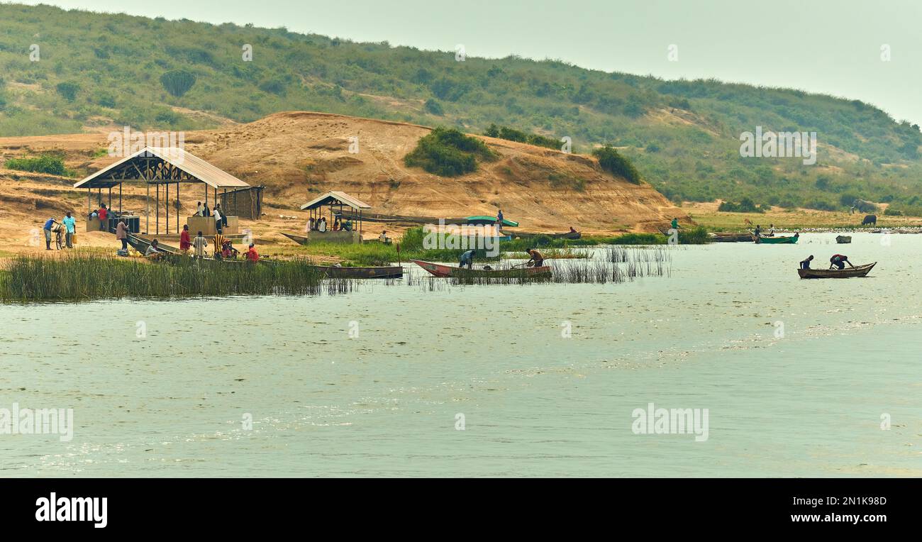 Hommes au travail sur la rive du lac Edward, en Ouganda. Hommes en bateaux de pêche. Les gens socialisent, socialisent. Banque D'Images