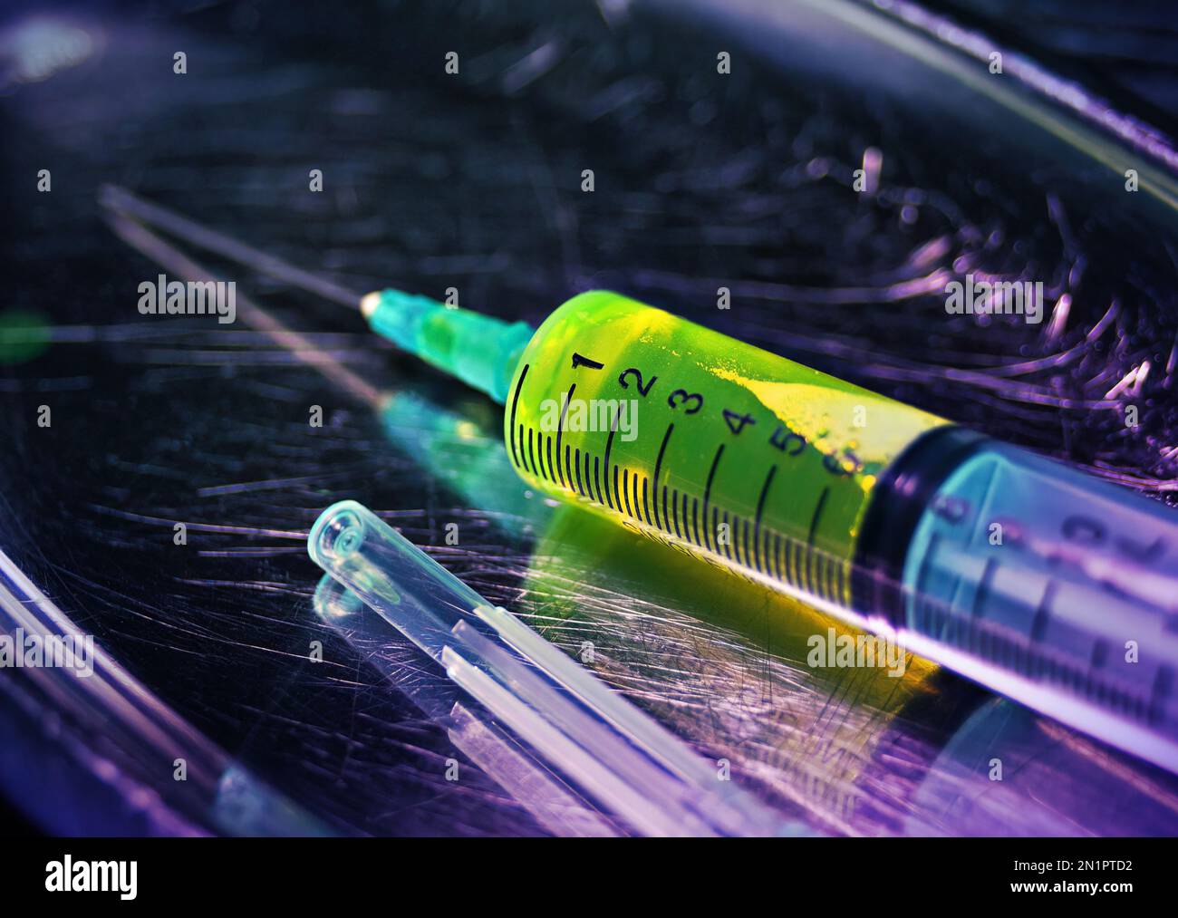 Liquide pharmaceutique vert à l'intérieur d'une seringue en plastique. Concept de vaccination, de recherche et de questions sociales médicales Banque D'Images
