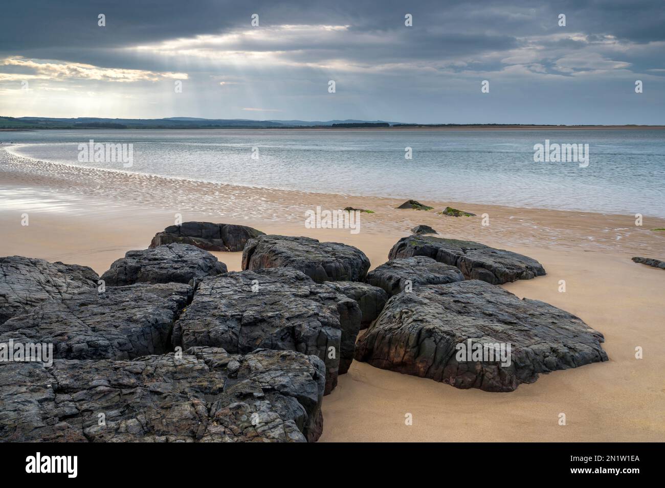 Rochers sur la rive de la baie de Budle, près de Bamburgh, Northumberland, Angleterre Banque D'Images