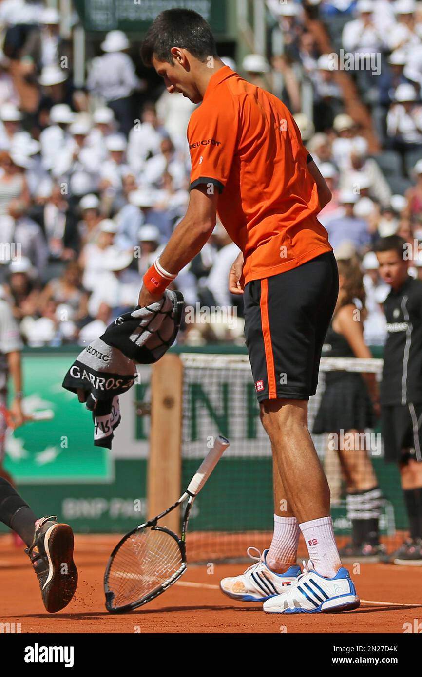 Serbia's Novak Djokovic breaks his racket after losing the second set
