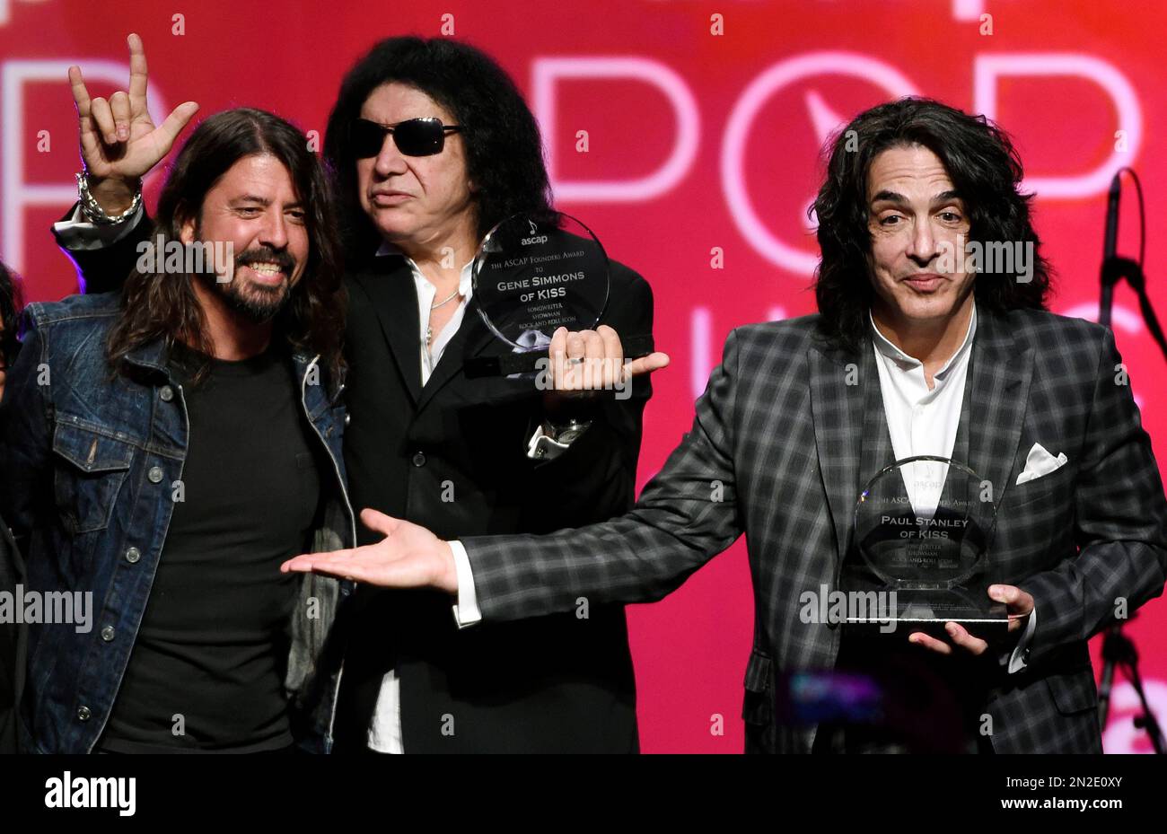 Gene Simmons, center, and Paul Stanley, right, of the rock band KISS pose with presenter Dave Grohl after receiving the ASCAP Founders Award at the 32nd Annual ASCAP Pop Music Awards at the Loews Hollywood Hotel on Wednesday, April 29, 2015, in Los Angeles. (Photo by Chris Pizzello/Invision/AP) Banque D'Images