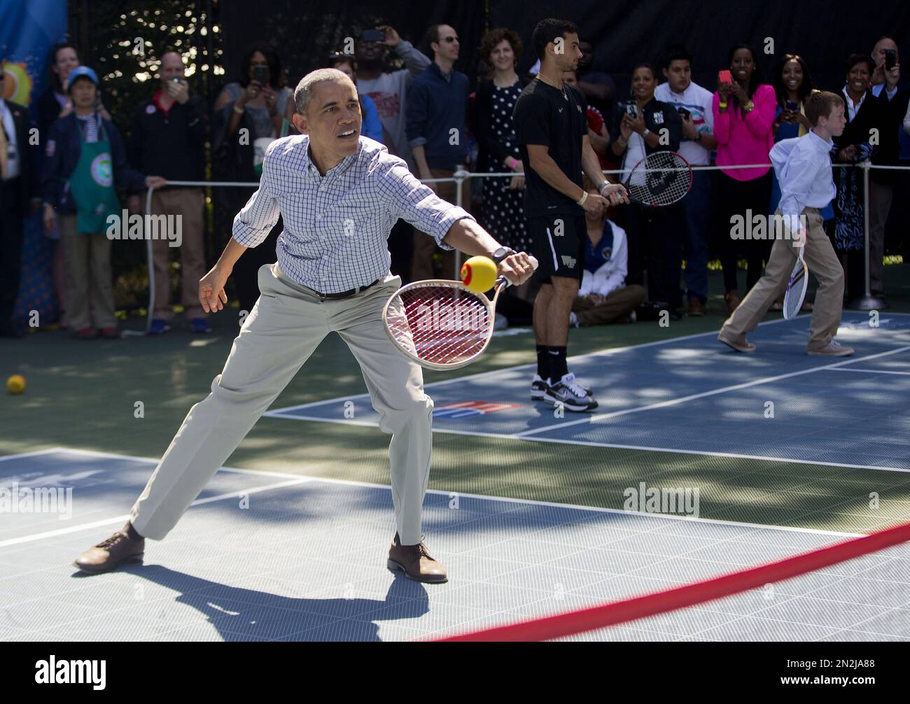 President Barack Obama plays tennis during the White House Easter Egg Roll on the tennis court on the South Lawn of the White House in Washington, Monday, April 6, 2015. Thousands of children gathered at the White House for the annual Easter Egg Roll. This year's event features live music, cooking stations, storytelling, and of course, some Easter egg roll. (AP Photo/Pablo Martinez Monsivais) Banque D'Images