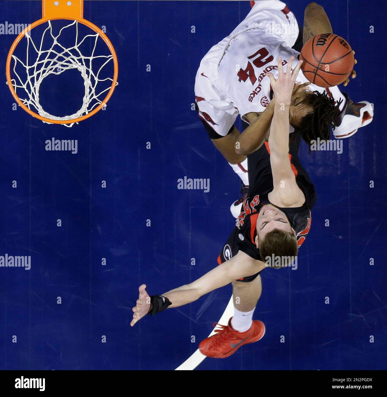 Arkansas guard Michael Qualls (24) shoots near forward Kenny