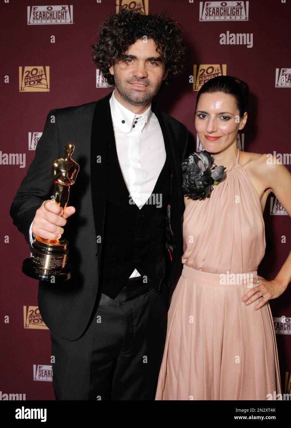 Armando Bo, left, and Luciana Marti are seen with his award for best original screenplay at the 20th Century Fox & Fox Searchlight Oscar Party at BOA Steakhouse on Sunday, Feb. 22, 2015, in West Hollywood, Calif. (Photo by Todd Williamson/Invision for Fox Searchlight Pictures/AP Images) Banque D'Images