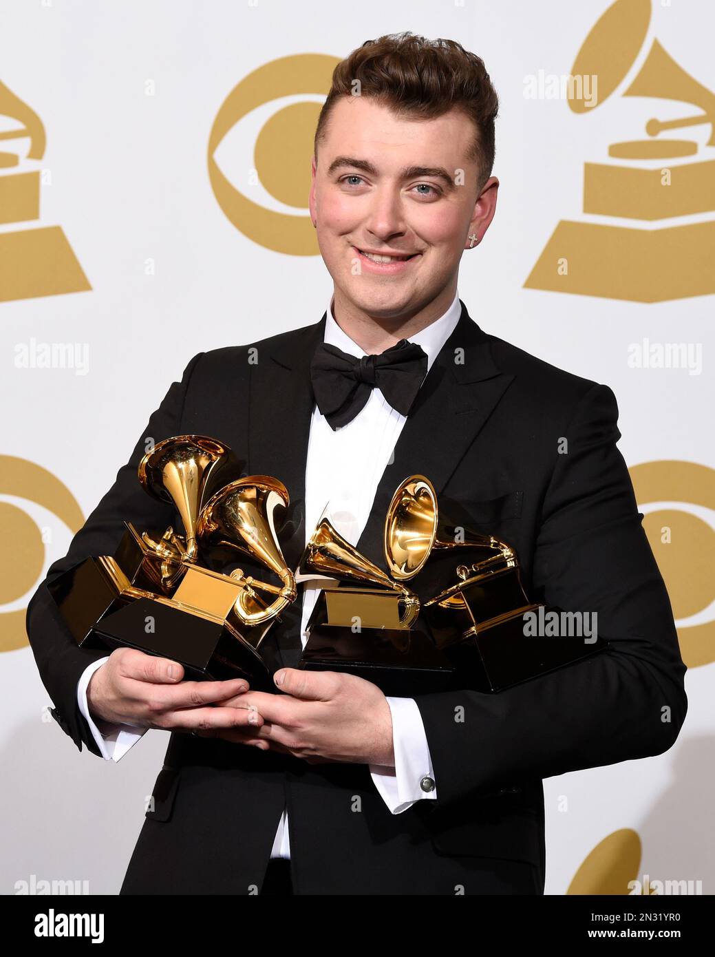 Sam Smith poses in the press room with the awards for best new artist