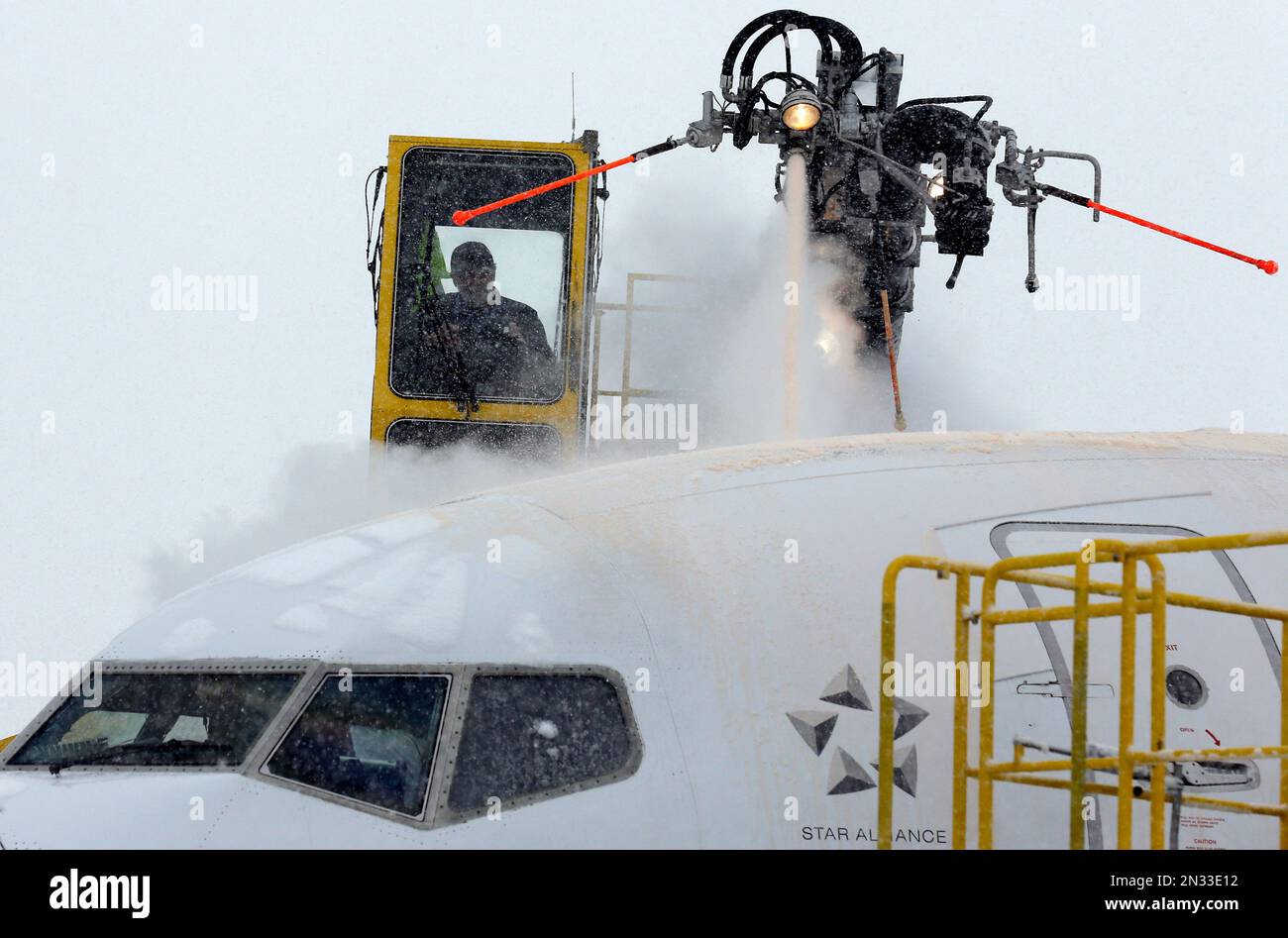 Crews work to deice a plane at O'Hare International Airport, Sunday