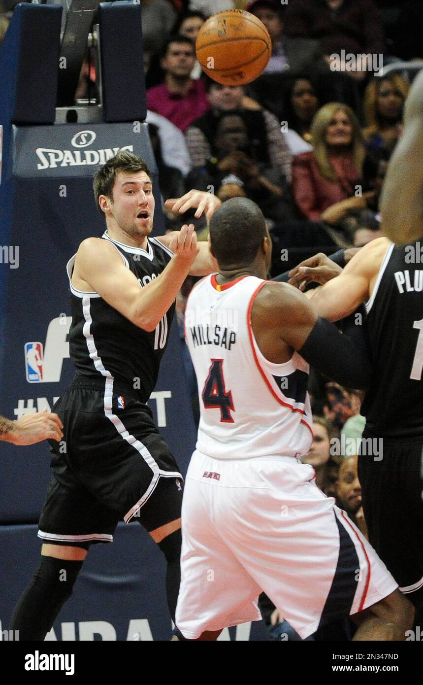 Brooklyn Nets guard Sergey Karasev (10), of Russia, passes as Atlanta Hawks forward Paul Millsap (4) defends during a NBA basketball game, Wednesday Jan. 28, 2015, in Atlanta. (AP Photo/John Amis) Banque D'Images