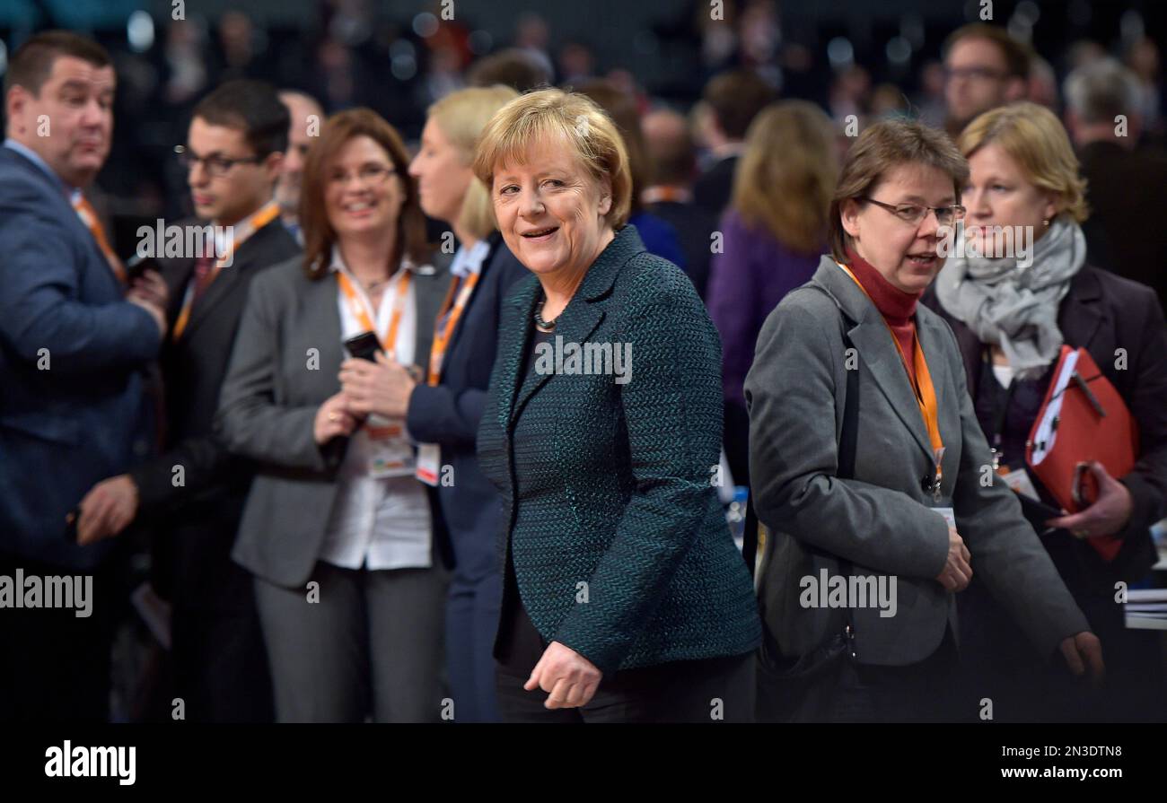 Chancellor and chairwoman of the German Christian Democrats, CDU, Angela Merkel, center, arrives at the 27th party convention in Cologne, Germany, Tuesday, Dec. 9, 2014. (AP Photo/Martin Meissner) Banque D'Images
