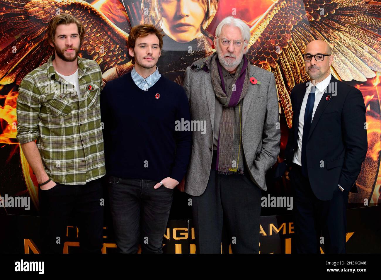 From left, Australian actor Liam Hemsworth, U.S actor Josh Hutcherson, Canadian actor Donald Sutherland and U.S actor Stanley Tucci pose for photographers at a photo call for The Hunger Games Mockingjay Part 1 at a central London venue, London, Sunday, Nov. 9, 2014. (Photo by Jonathan Short/Invision/AP) Banque D'Images