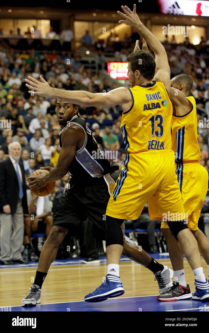 San Antonio Spurs' Kawhi Leonard, left, and ALBA's Marko Banic from Croatia, right, challenge for the ball during an NBA Global Games basketball match between US team San Antonio Spurs and German team ALBA Berlin in Berlin, Germany, Wednesday, Oct. 8, 2014. (AP Photo/Michael Sohn) Banque D'Images