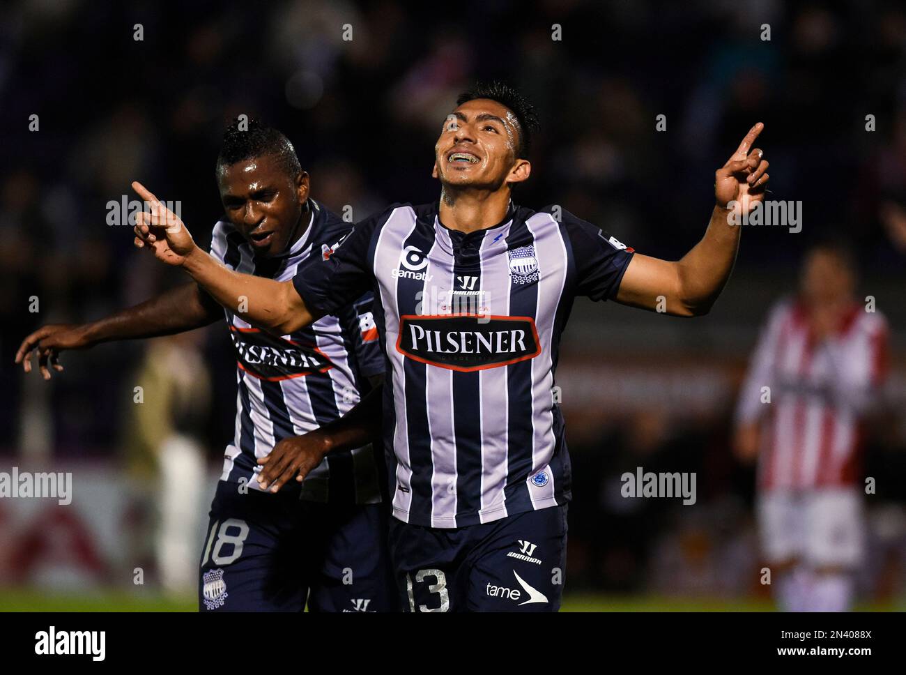 Angel Mena of Ecuador's Emelec, center, celebrates with Miller Bolanos, the scoring of a goal against Uruguay's River Plate during a Copa Sudamericana soccer match in Montevideo, Uruguay, Thursday, Sept. 25, 2014. (AP Photo/Matilde Campodonico) Banque D'Images