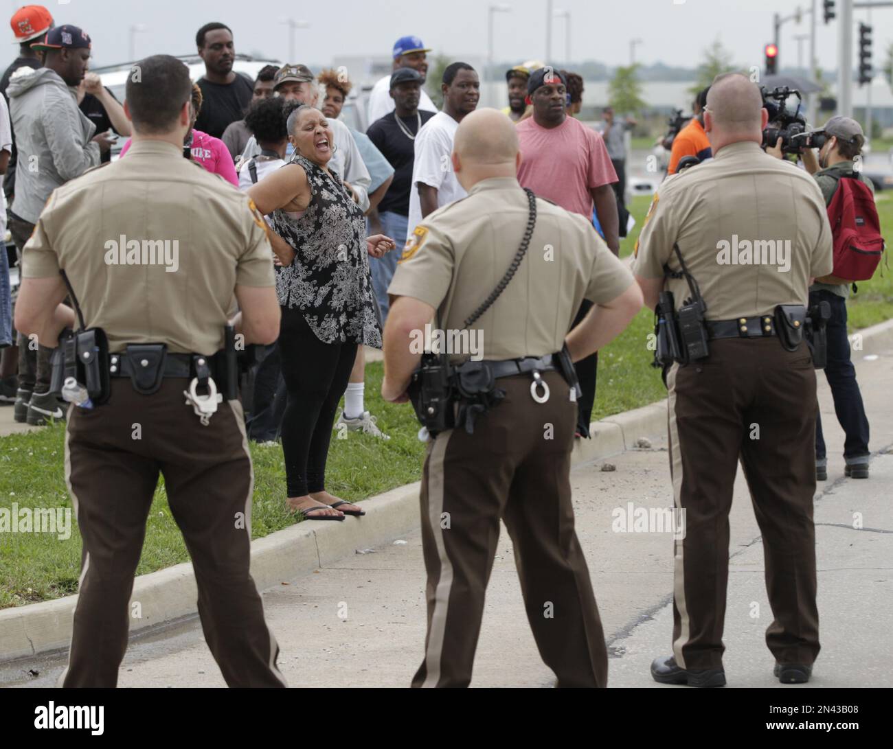 A protester shouts at St. Louis county police officers during a protest  aimed at shutting down Interstate 70 in Berkeley, Mo. on Wednesday, Sept.  10, 2014 near the St. Louis suburb of