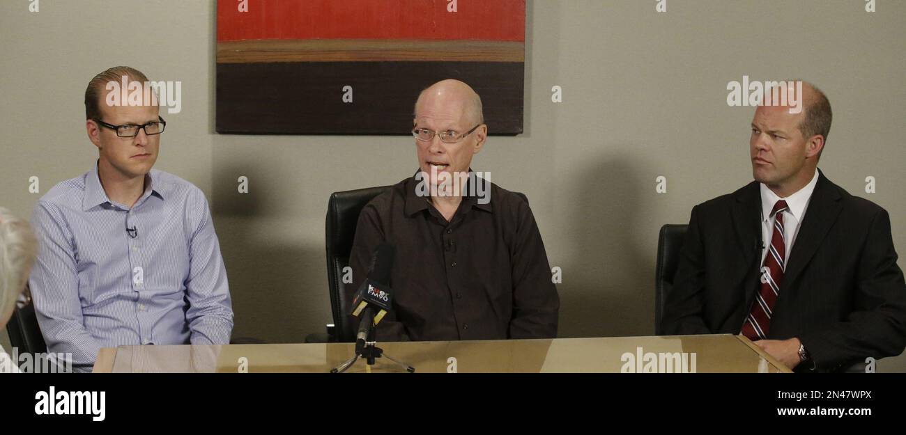 Jim Harding, center, speaks about his wife, Jan Harding, during a news
