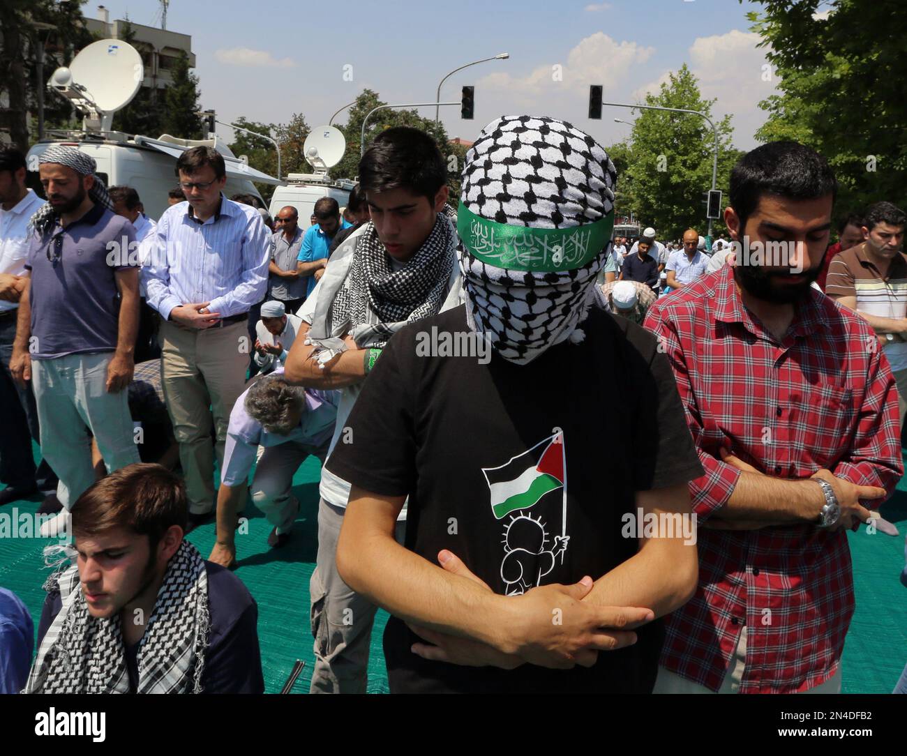 Pro-Palestinian Turks pray on the main Ataturk Boulevard as they stage ...