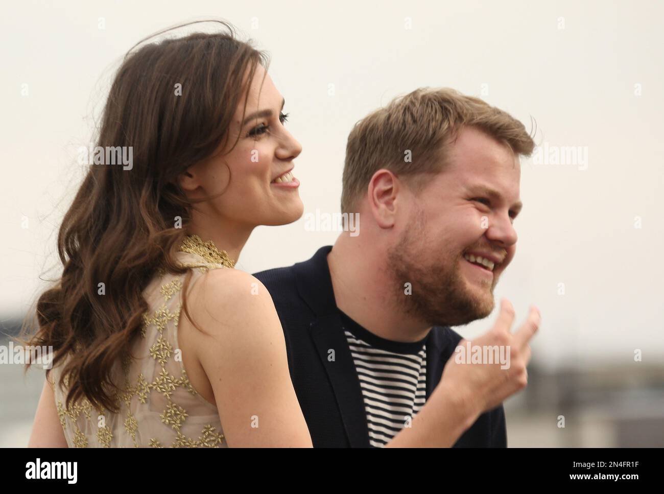 Actors Keira Knightley and James Corden laugh as they are interviewed on the rooftop of picturehouse cinemas in central London during a photo call for the film Begin Again, Wednesday, July 2, 2014. (Photo by Joel Ryan/Invision/AP) Banque D'Images
