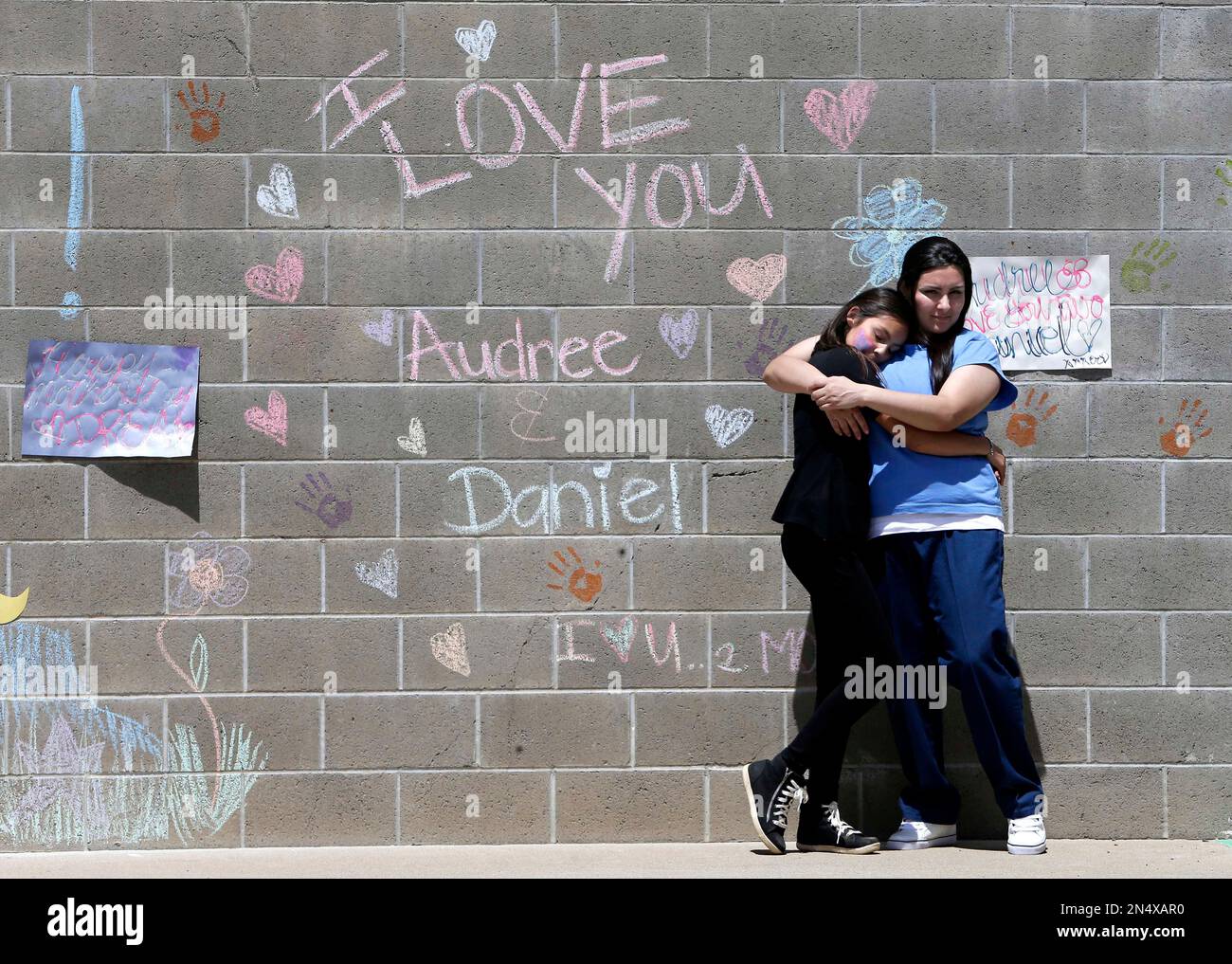 In this photo taken May 3, 2014, Audree Loaiza,11, left, hugs her ...