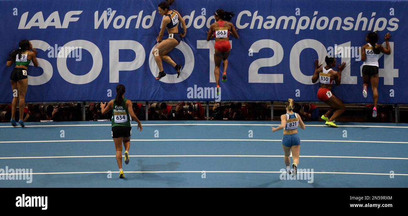 Nigeria's Gloria Asumnu, Cook Islands ' Patricia Taea, Cyprus' Ramona Papaioannou, United States' Lakeisha Lawson, San Marino's Martina Pretelli, Trinidad and Tobago's Geronne Black and Gabon's Ruddy Zang Milama, from left, slow down after a women's 60m heat during the Athletics Indoor World Championships in Sopot, Poland, Saturday, March 8, 2014. (AP Photo/Alik Keplicz) Banque D'Images