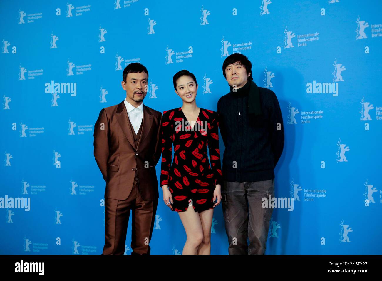 From left, actors Liao Fan, Gwei Lun Mei and director Diao Yinan pose for photographers at the photo call for the film 'Black Coal, Thin Ice' during the International Film Festival Berlinale in Berlin, Wednesday, Feb. 12, 2014. (AP Photo/Markus Schreiber) Banque D'Images