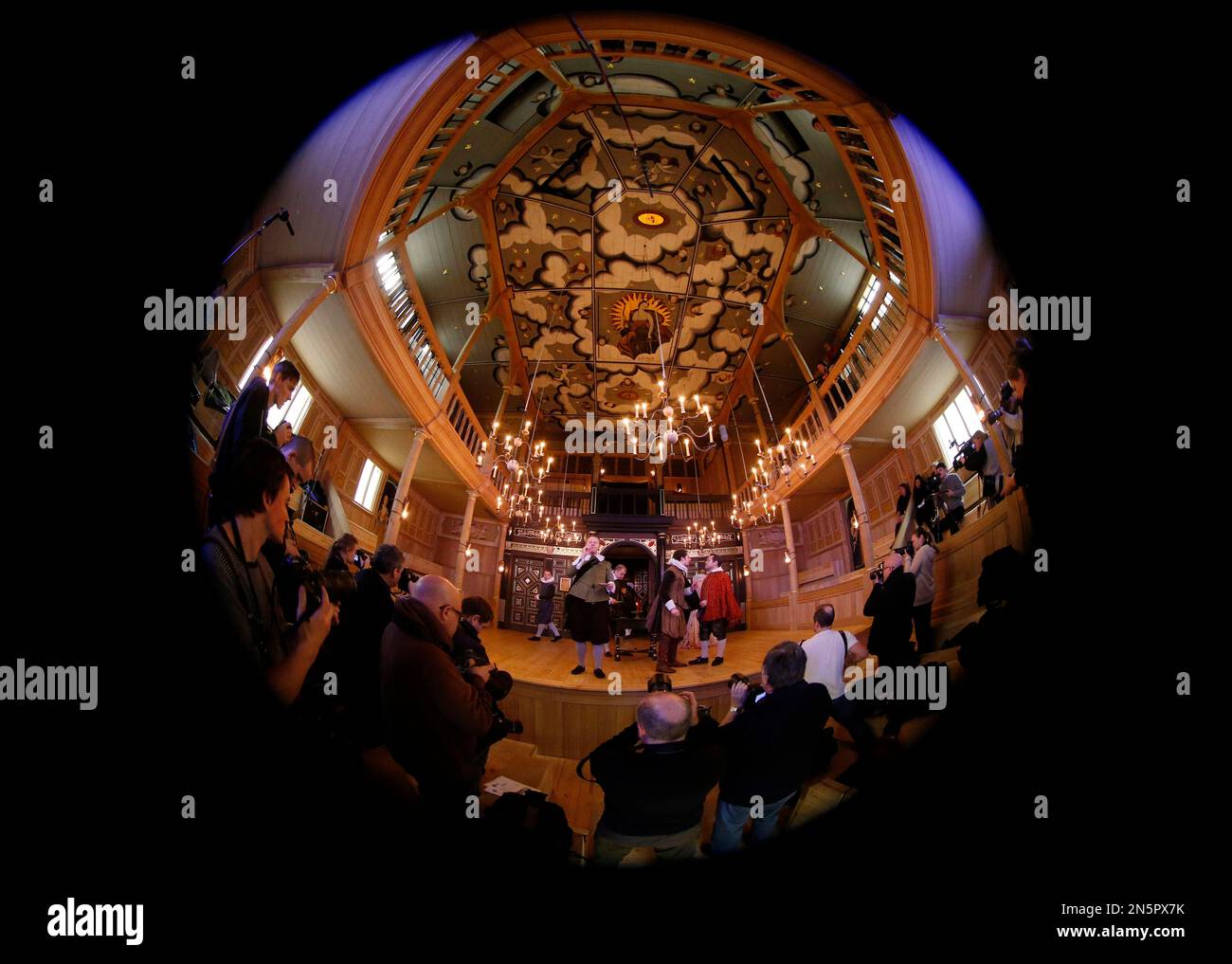 Taken with a fisheye lens, cast members perform a scene from the play 'The Duchess of Malfi' during a photocall in the Shakespeare's Globe new indoor theatre Sam Wanamaker Playhouse in London, Tuesday, Jan. 14, 2014. The theatre is a reproduction of a Jacobean playhouse and it seats 340 people with two tiers of galleried seating and an historically accurate pit seating area. (AP Photo/Sang Tan) Banque D'Images