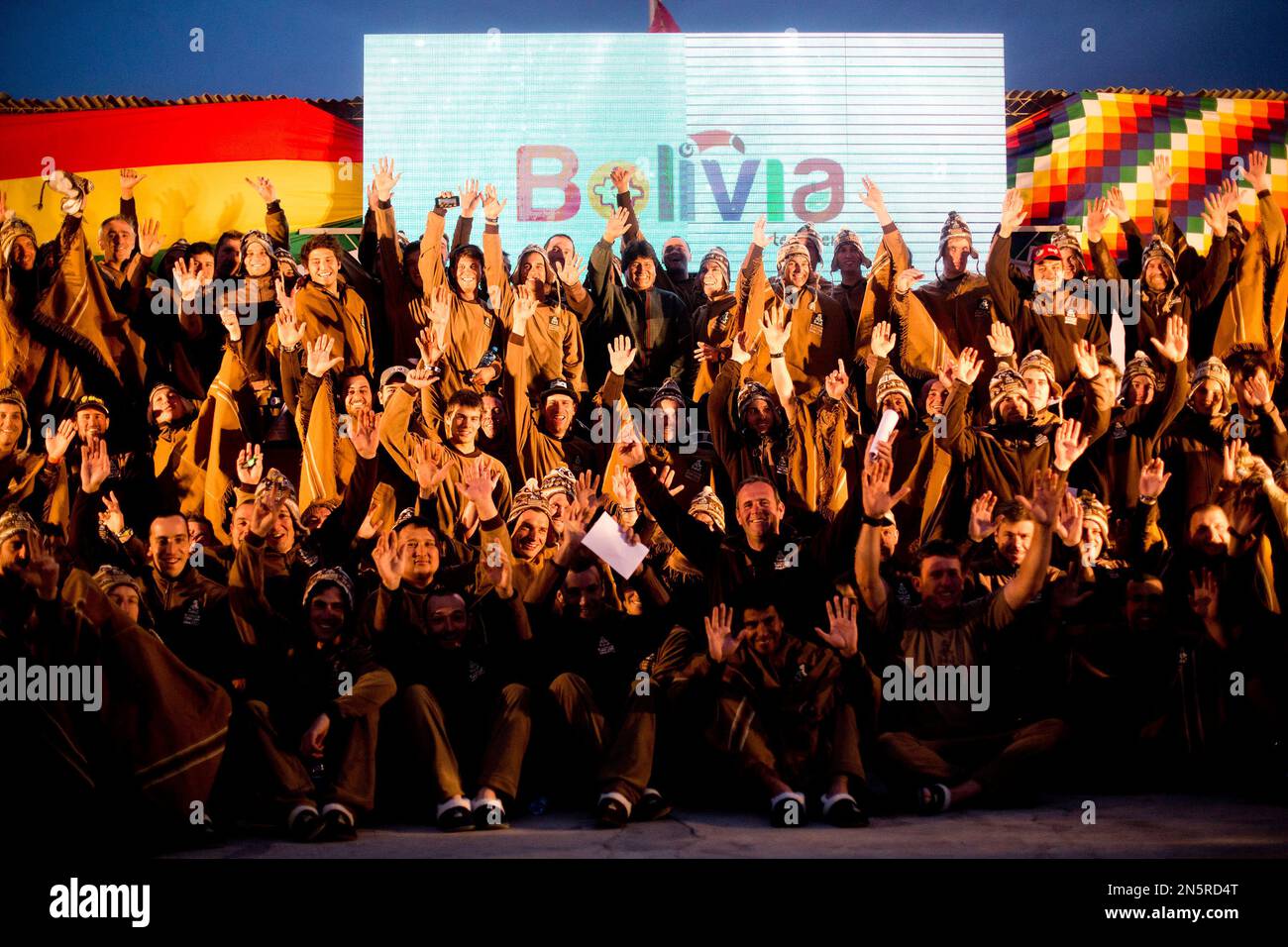 Bolivian President Evo Morales, center top, poses with Dakar Rally competitors at the end of the seventh stage in Uyuni, Bolivia, Sunday, Jan. 12, 2014. (AP Photo/Victor R. Caivano) Banque D'Images