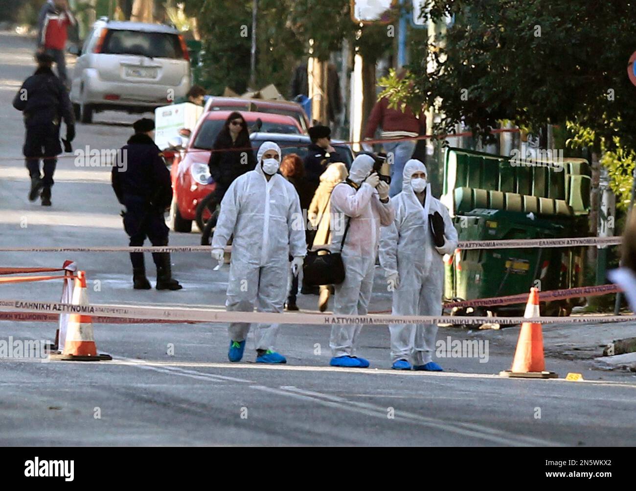 Police investigate a street outside the residence of German Ambassador to Athens Wolfgang Dold, in the northern suburb of Halandri, Greece Monday, Dec. 30, 2013. Police in Greece said the home of Germany’s ambassador was sprayed with gunfire from automatic weapons in an overnight attack that caused no injuries. (AP Photo/Thanassis Stavrakis) Banque D'Images