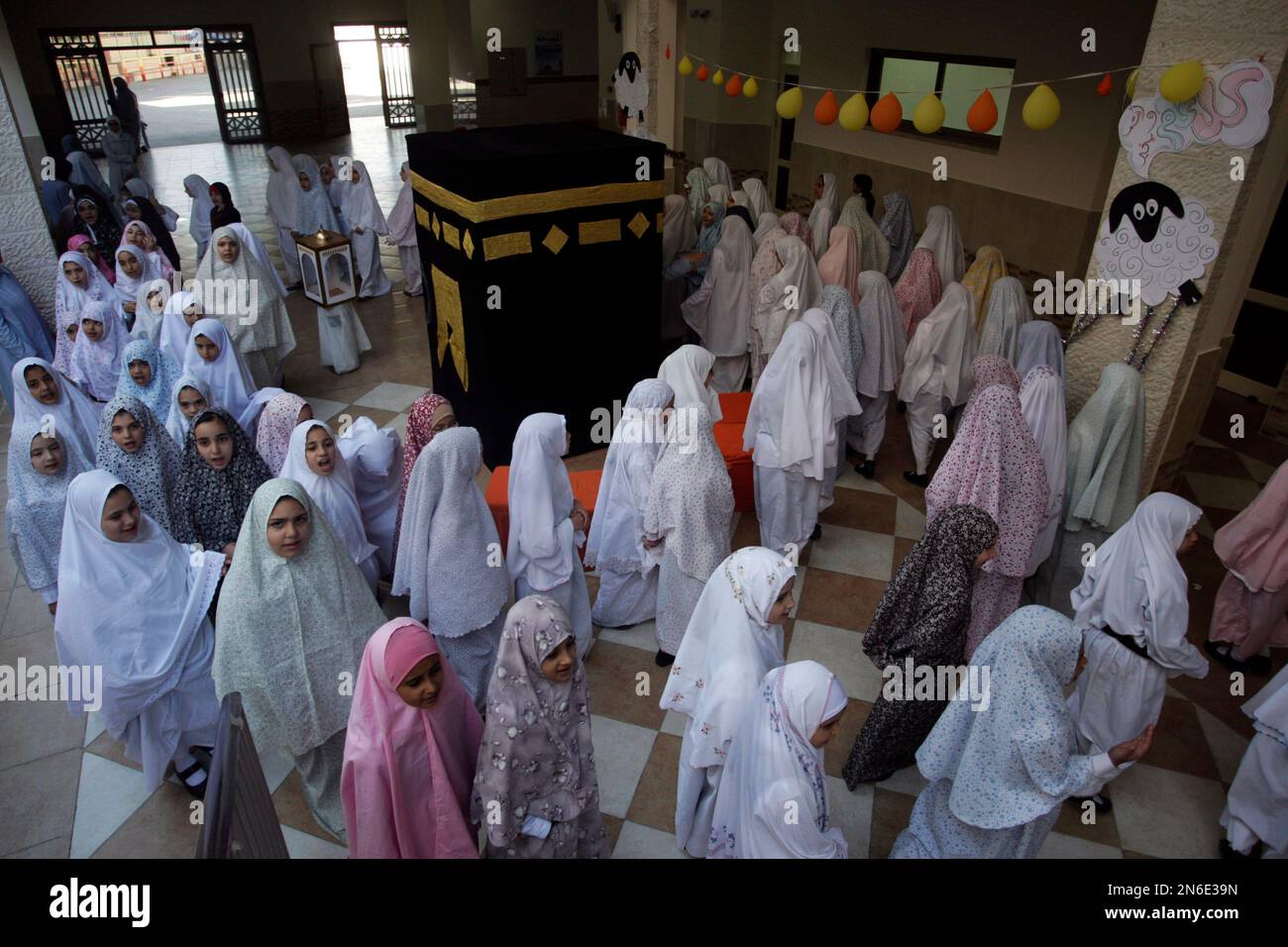 palestinian-students-gather-around-a-model-that-represents-the-kaaba-a