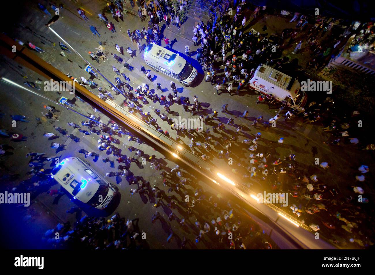 Ambulances stand by to evacuate injured protesters after riot police flooded the Gazi Park with tear gas during clashes at the Taksim Square in Istanbul Tuesday, June 11, 2013. Hundreds of police in riot gear forced through barricades in the square early Tuesday, pushing many of the protesters who had occupied the square for more than a week into a nearby park. (AP Photo/Vadim Ghirda) Banque D'Images