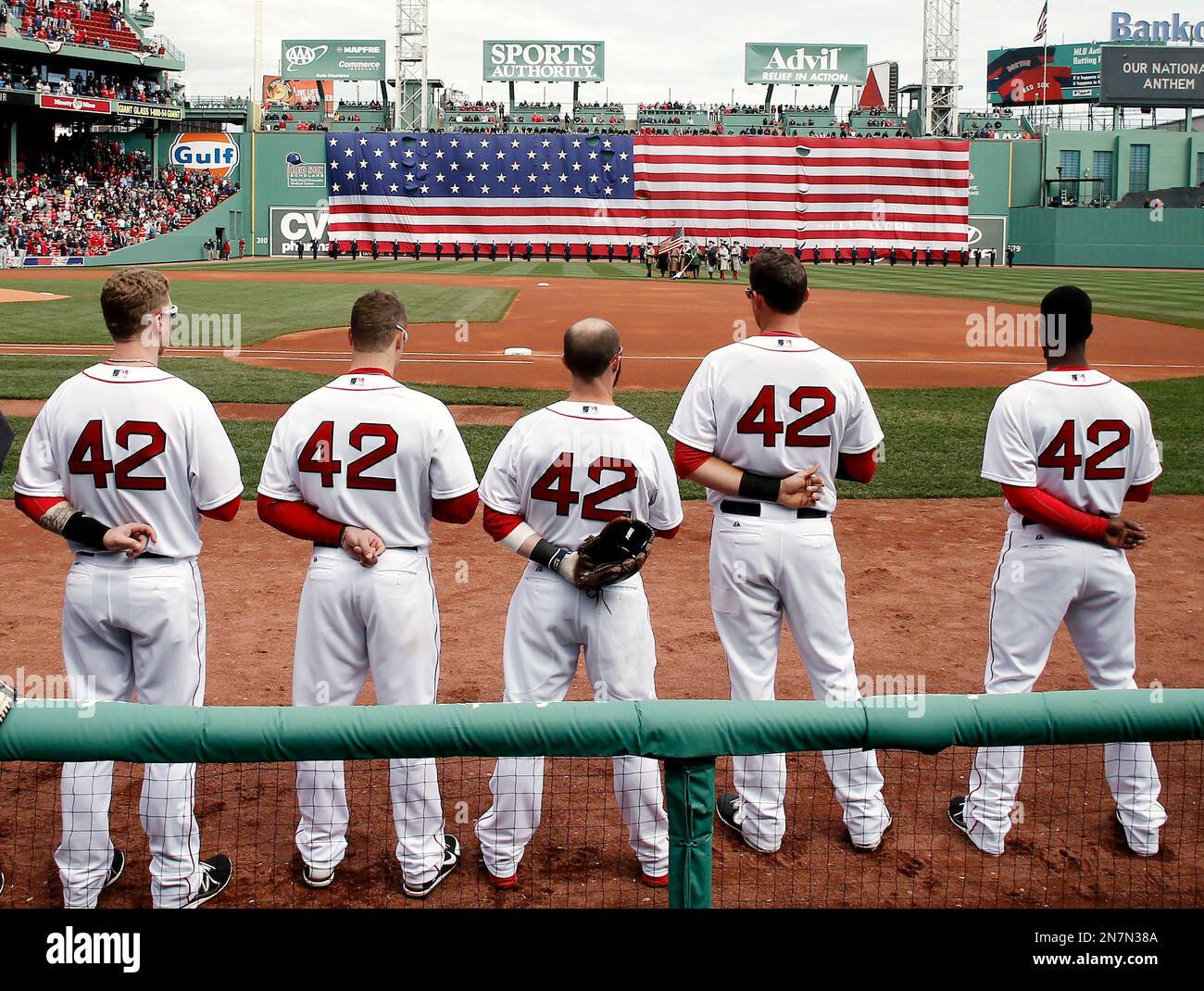 Boston Red Sox players line up for the National Anthem all wearing