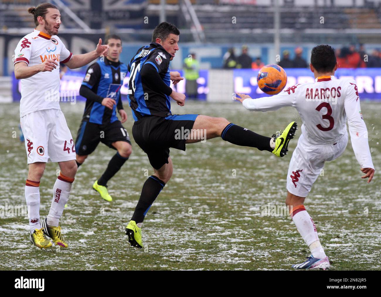 Atalanta's forward Igor Budan, center, of Croatia, is challenged by AS Roma Brazilian defender Marquinhos, right, and Federico Balzaretti during a Serie A soccer match in Bergamo, Italy, Sunday, Feb. 24, 2013. AS Roma won 3-2. (AP Photo/Felice Calabro') Banque D'Images