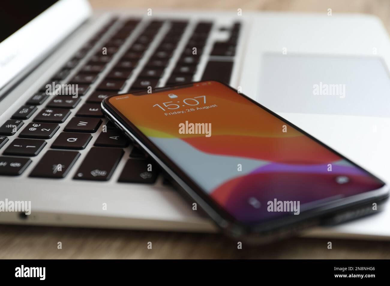 MYKOLAIV, UKRAINE - 28 AOÛT 2020 : iPhone 11 et ordinateur portable MacBook sur table en bois, gros plan Banque D'Images