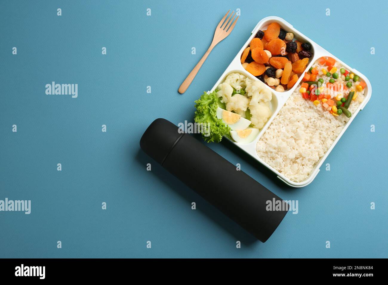 Thermos et boîte à lunch avec nourriture sur fond bleu clair, plat. Espace  pour le texte Photo Stock - Alamy