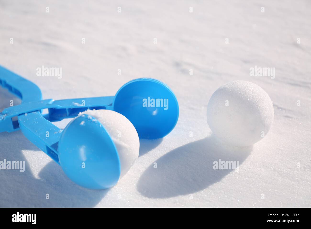 Boules de neige et outil en plastique bleu clair à l'extérieur le jour d'hiver, gros plan Banque D'Images