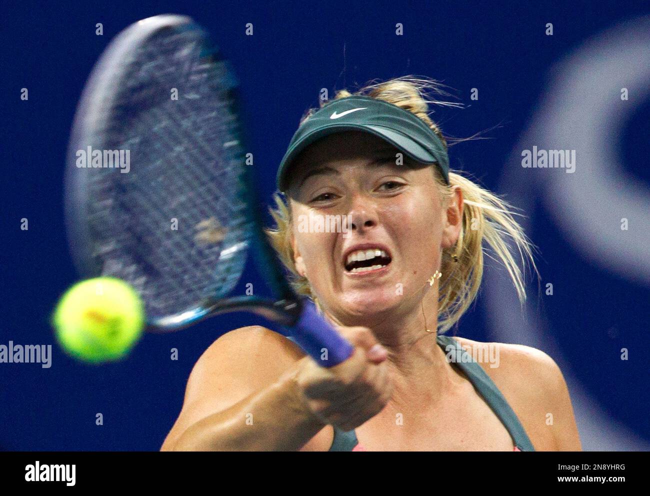 Russian Maria Sharapova hits a forehand shot to Simona Halep of Romania during their first round match at the China Open tennis tournament in Beijing Monday, Oct. 1, 2012. Sharapova defeated Halep 7-6, 7-6. (AP Photo/Andy Wong) Banque D'Images