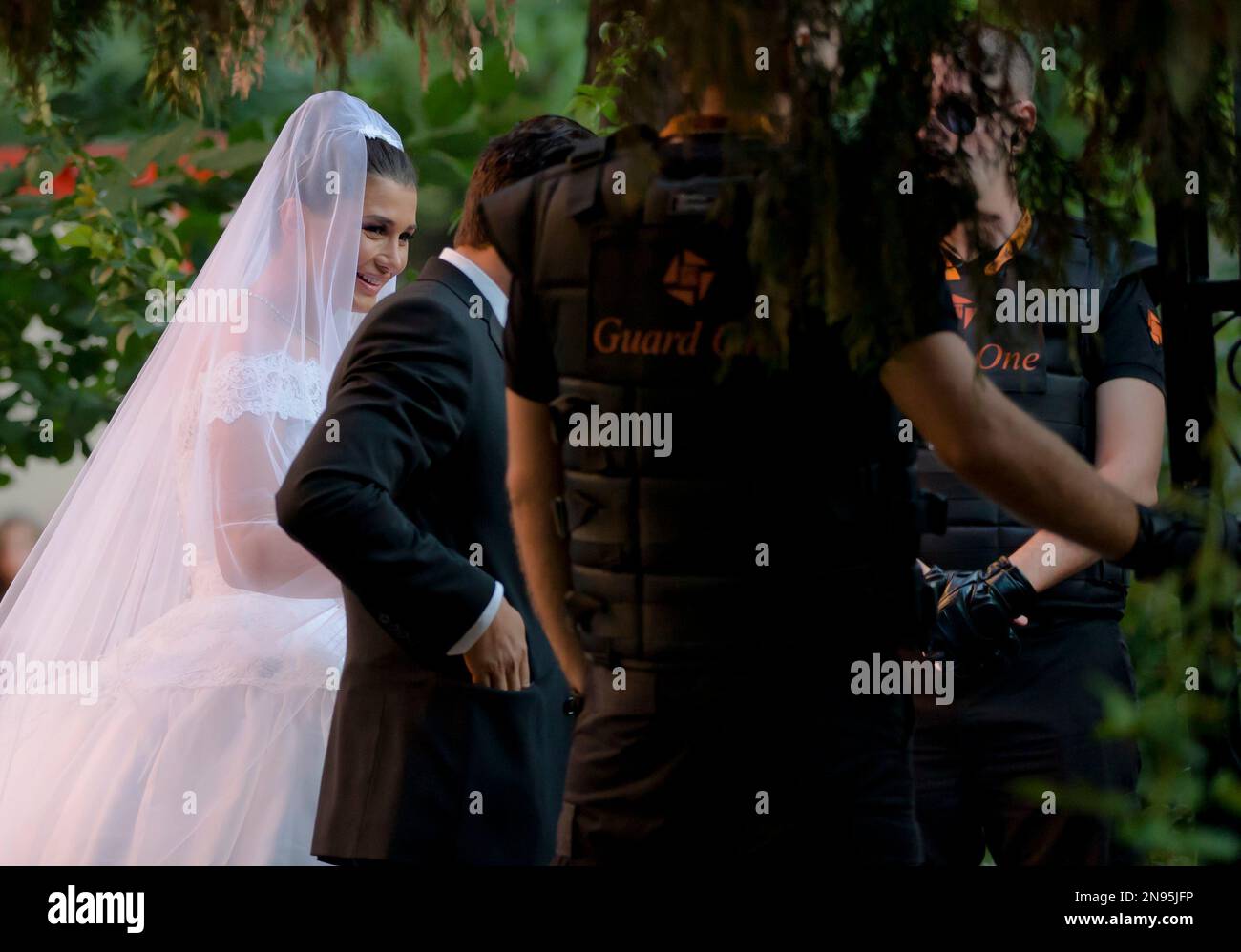Romanian President Traian Basescu's daughter Elena, left, is seen at her wedding in Bucharest, Romania, Saturday, Sept. 1, 2012. Elena Basescu, a European Parliament member, married on Saturday as dozens of protesters gathered outside the church where the ceremony took place chanting anti-presidential slogans and demanding President Basescu's resignation.(AP Photo/Vadim Ghirda) Banque D'Images