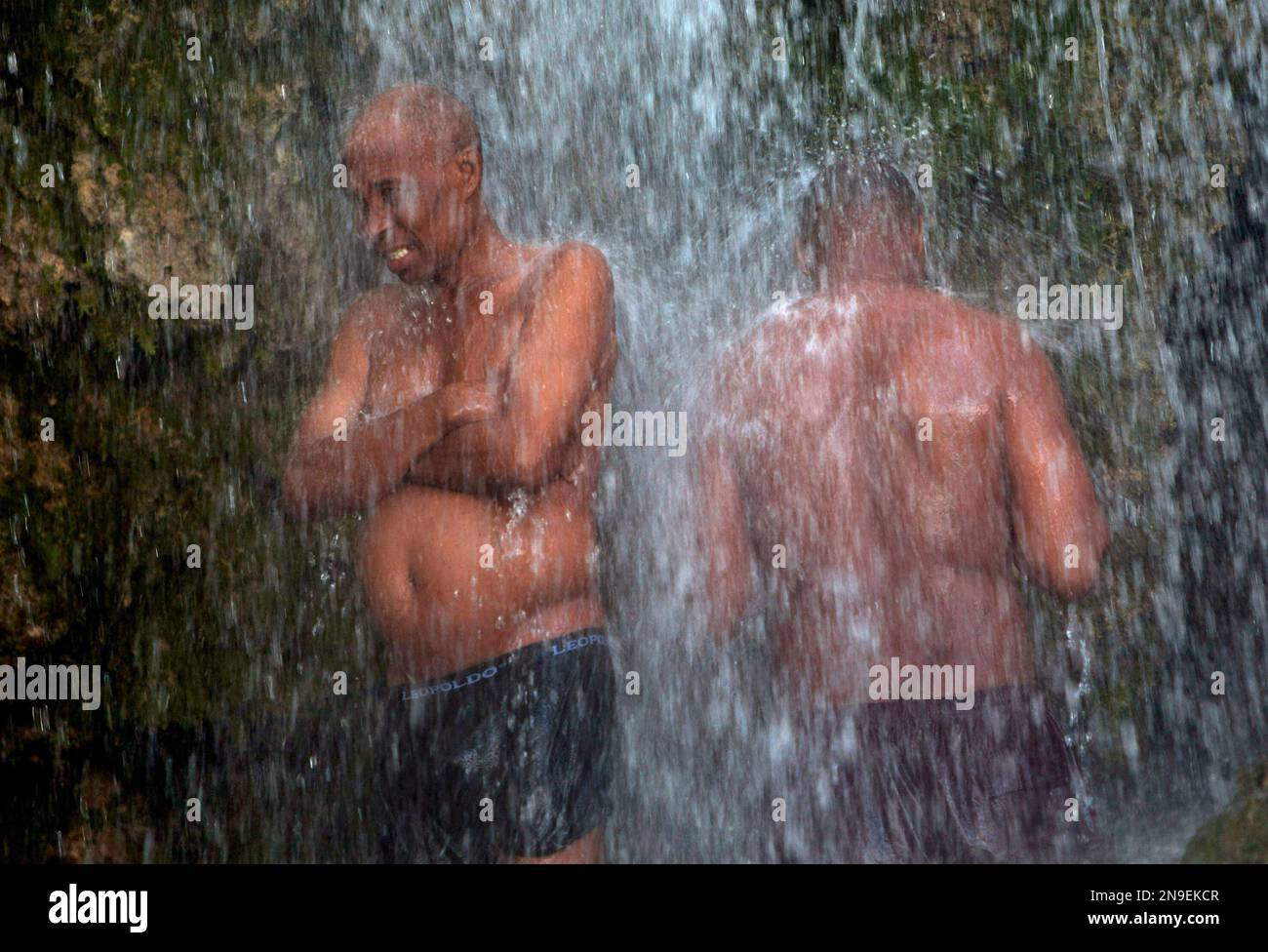 Pilgrims bath in a waterfall believed to have purifying powers in Saut ...