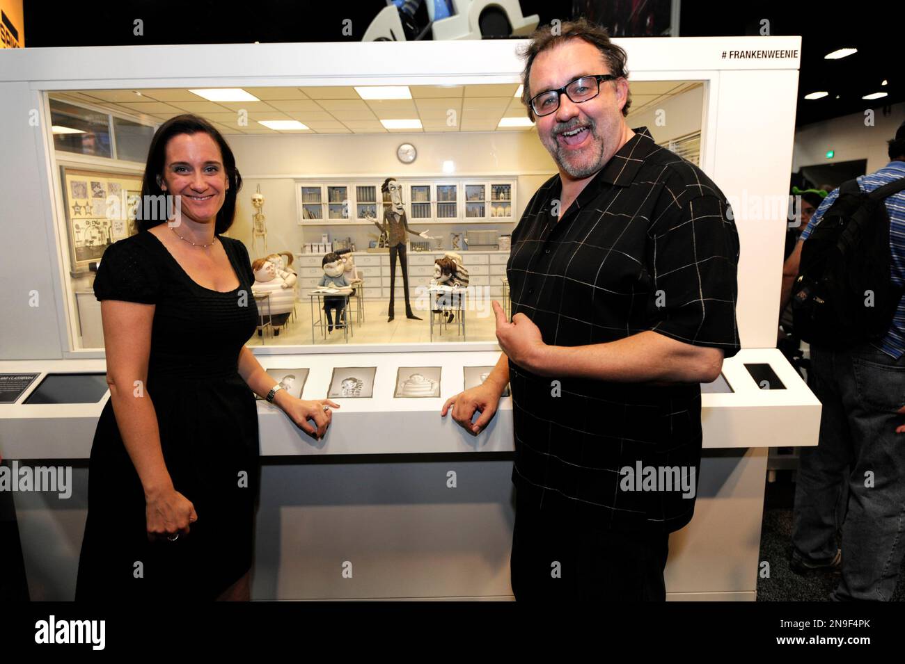 Producer Allison Abbate, left, and executive producer Don Hahn, left, pose with a set from the Disney Tim Burton movie " Frankenweenie" on display at Comic-Con preview night held at the San Diego Convention Center on Wednesday July 11, 2012, in San Diego. (Photo by Denis Poroy/Invision/AP) Banque D'Images