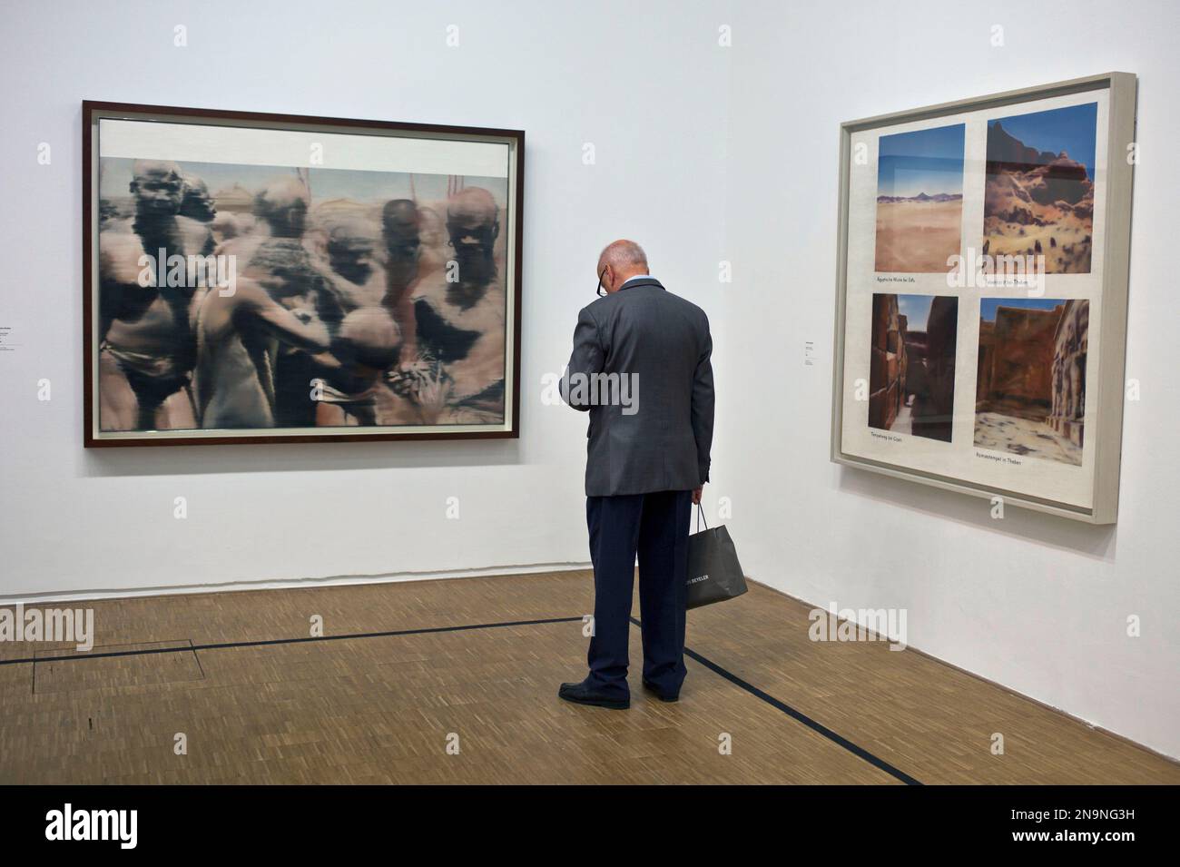 A member of media looks at paintings of German artist Gerhard Richter on the eve of the opening of his exhibition "Gerhard Richter: Panorama", at the Centre Pompidou, Monday, June 4, 2012. On left: "Neger", 1964, and at right, "Egyptian Landscape", 1964. (AP Photo/Thibault Camus) Banque D'Images
