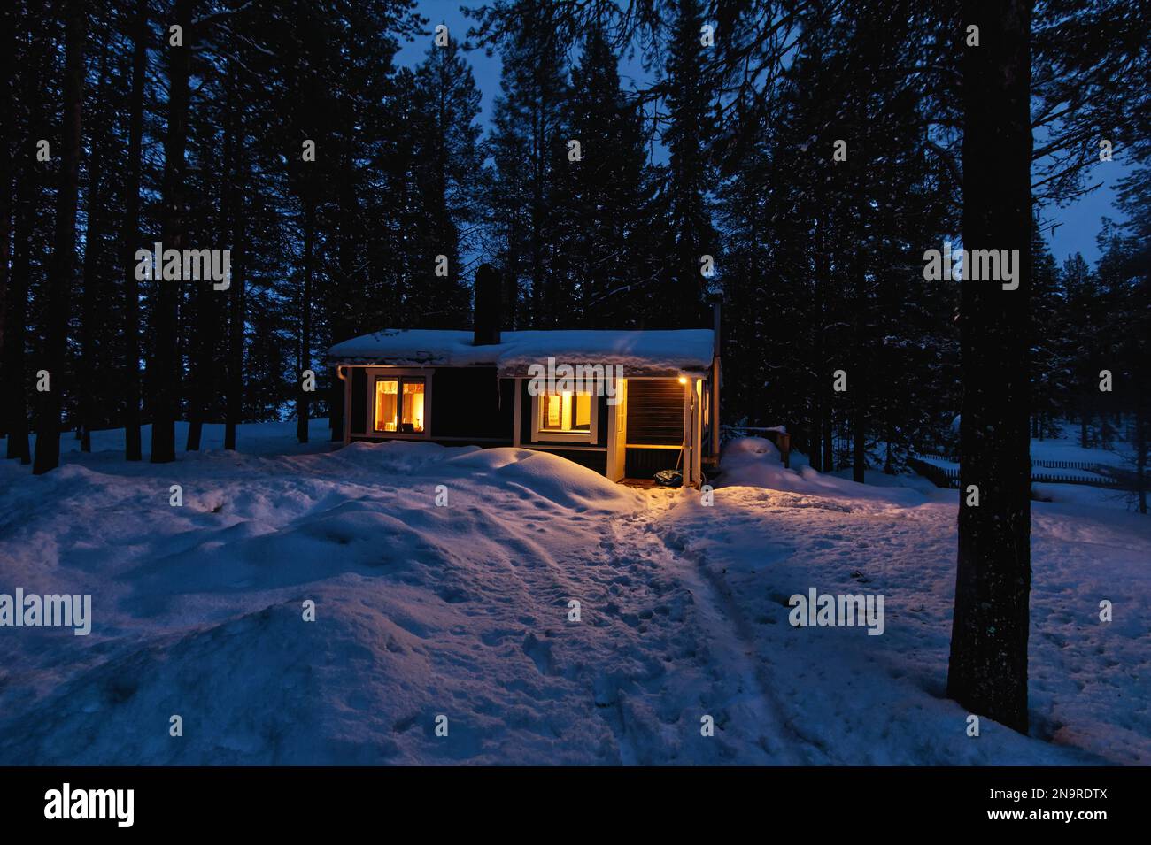 Confortable cabine en bois dans une forêt enneigée dans le nord de la Suède, Kiruna Banque D'Images