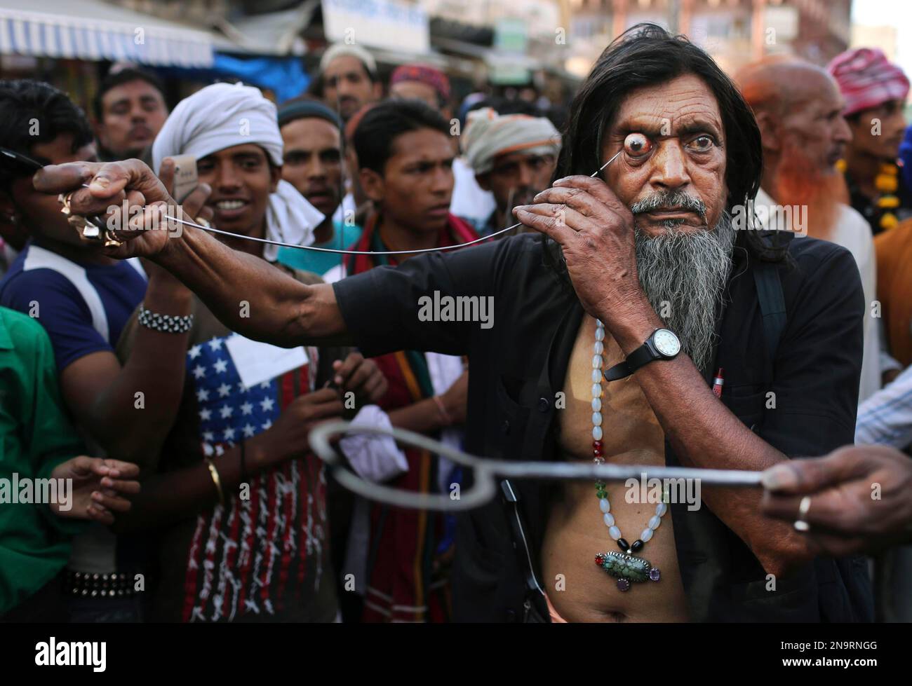 An Indian Sufi Muslim devotee uses a sharp object as he self ...